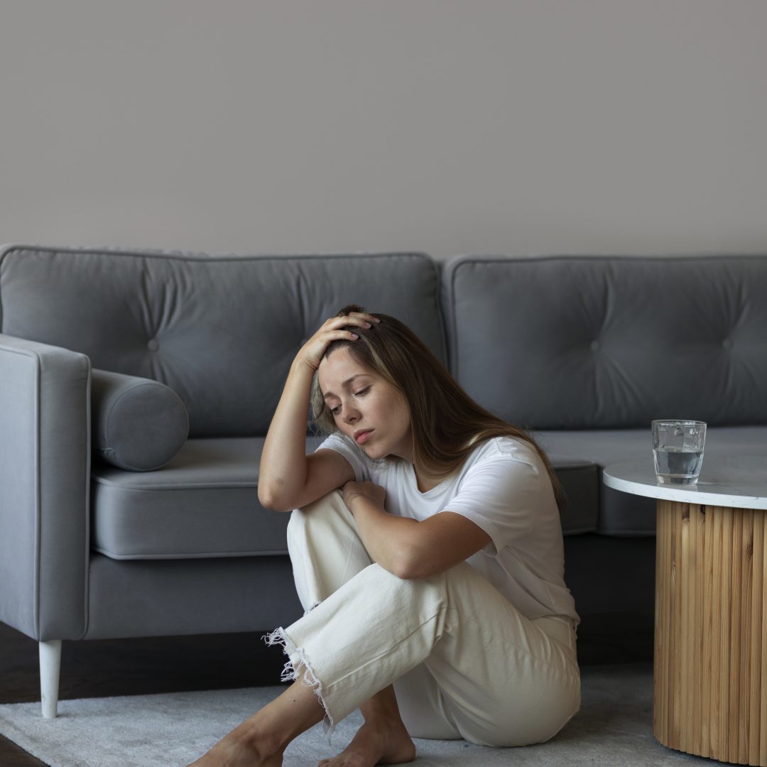 full-shot-anxious-woman-sitting-floor